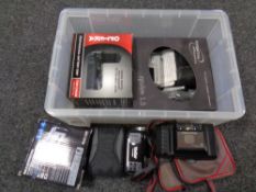 A plastic storage box with lid containing a quantity of digital video cameras,