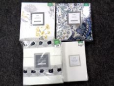 A basket of four Dunelm duvet cover sets,