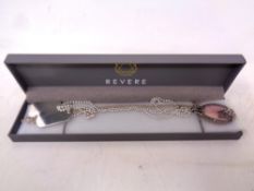 A set of sterling Silver dog tags together with a Silver and mother of Pearl necklace.