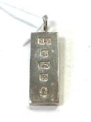 A large silver ingot pendant