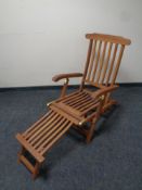 A teak steamer garden armchair with foot rest
