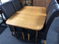 A mid century teak dining table