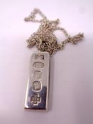 A silver ingot on chain.