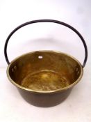A brass cast iron handled jam pan