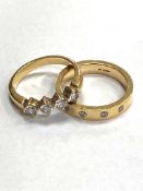 A two part engagement ring suite comprising of heavy 18ct gold band ring set with four diamonds (8.