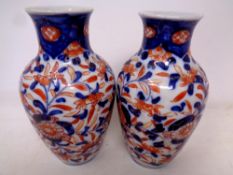 A pair of Japanese glazed porcelain Imari vases. Height 15.