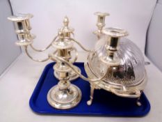 A tray containing a pair of three-way silver plated candelabrum together with an oval silver plated