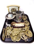 A tray containing a quantity of horse brasses, brass nut cracker, miniature globe on stand,