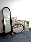 A cheval mirror and a wall mirror in a mahogany finish together with three further gilt framed