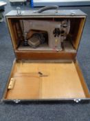 A 20th century Singer electric sewing machine in case.
