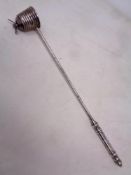 A white metal candle snuffer modelled as a bee on a hive