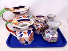 A tray containing a set of 19th century graduated ironstone jugs and two Masons jugs