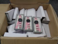 A box containing a quantity of Lyfe wristwatches on fabric straps.