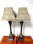 A pair of contemporary table lamps with tasseled shades