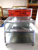 A stainless steel and glass counter top food cabinet