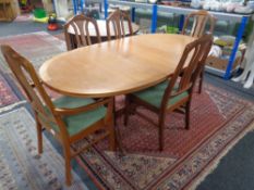 A 20th century oval Nathan teak extending dining table together with five chairs