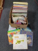 A box containing a quantity of vinyl LPs and 7