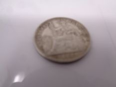 A French 1900 ten cent silver coin.