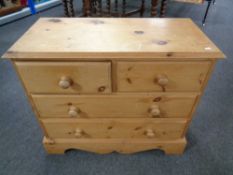 A stripped pine four drawer chest