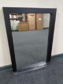 A contemporary black framed mirror
