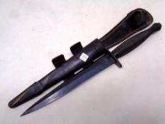 A Fairbairn Sykes Third Pattern dagger in leather sheath.
