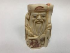 A Japanese bone carving - Village Elder with Scroll.