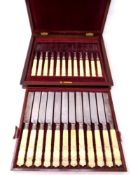 A 19th century inlaid mahogany canteen containing 24 pieces of fish cutlery