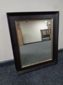 A contemporary black framed mirror