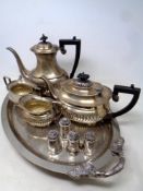 A silver plated twin handled serving tray on raised feet together with a four piece silver plated