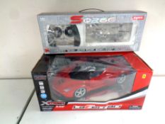 An X Street 1:12 scale Ferrari remote control car together with a Gyro remote control transport