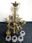 A continental decorative brass chandelier with glass shades.