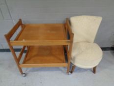 A mid 20th century teak two-tier tea trolley together with a bedroom chair upholstered in a floral