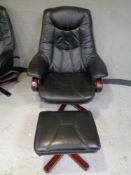 A stained beech framed armchair upholstered in black leather together with matching stool.