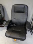 An electric massage armchair upholstered in black leather.
