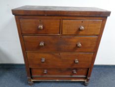 A late Victorian stained pine chest of five drawers