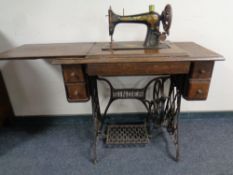 A Singer treadle sewing machine in oak table