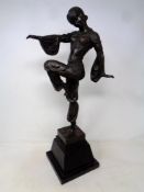 An after Chiparus bronze sculpture of an Art Deco dancer on a black marble base.