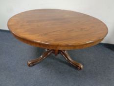 A Victorian rosewood circular dining table.