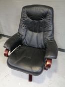 A stained beech framed armchair upholstered in black leather