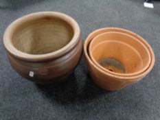 A glazed pottery circular planter together with two terracotta planters