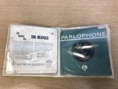 A folder of 45 rpm singles to include The Rolling Stones and The Beatles