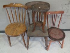 A carved beech two-tier plant stand together with three rail back chairs.