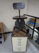 A Bisley four drawer office chest together with a swivel typists chair.