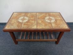 A rectangular teak tile topped coffee table