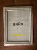 Eighteen Xenos silver-finish photo frames, 13 cm x 18 cm, all brand new and still wrapped.