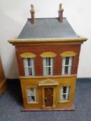 A 20th century doll's house with dolls and furniture