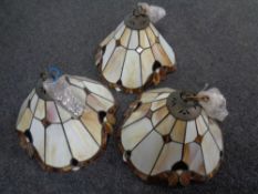 A set of three leaded glass light shades