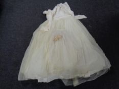 A vintage wedding dress with veil and head band.