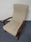 A stained beech armchair in beige upholstery