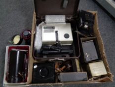 A box containing a large quantity of camera equipment to include Sunzoom lense projector,